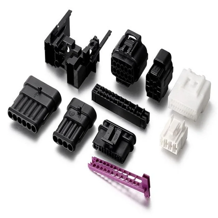 Mixed molded plastic connector and housing components