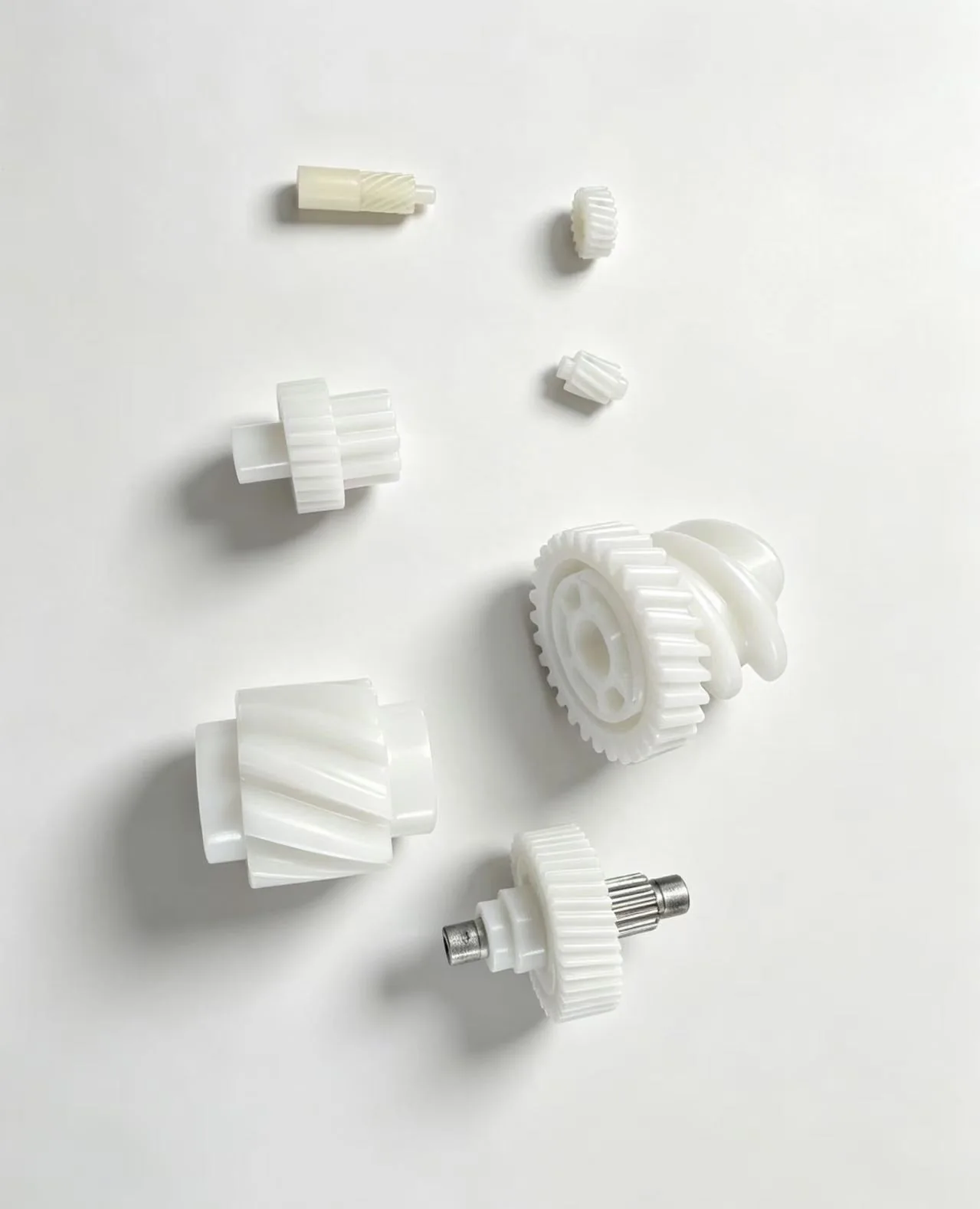 Small white molded gear components