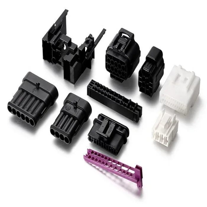 Mixed molded plastic connector and housing components