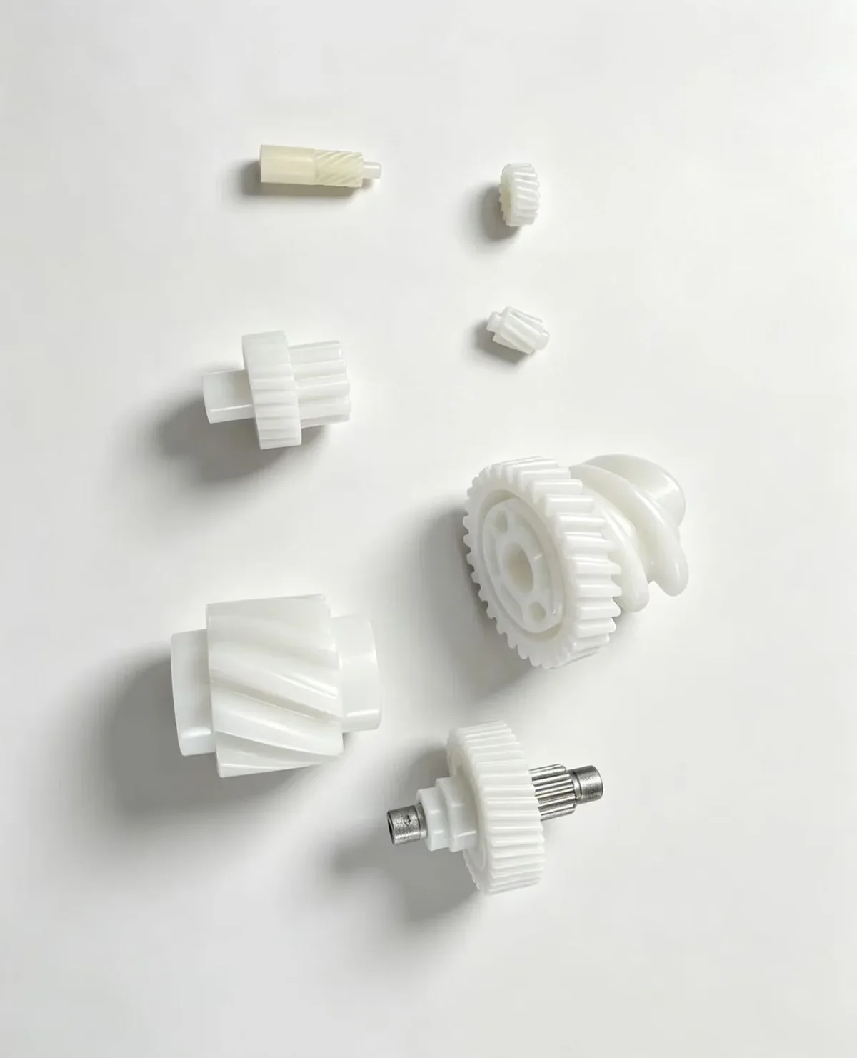 Small white molded gear components